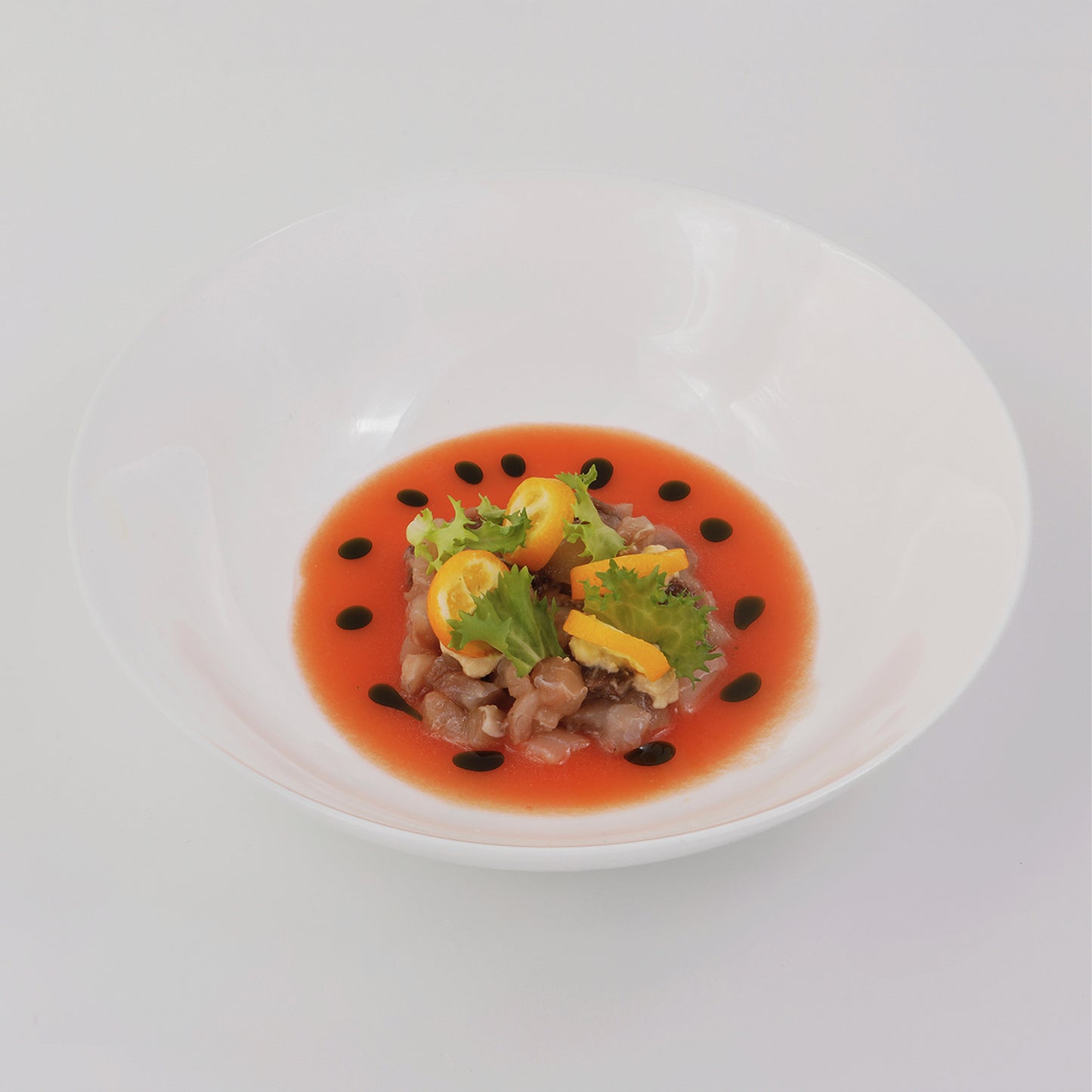 Blackish carpaccio, tomato and watermelon gazpacho, dehidrated kumquat