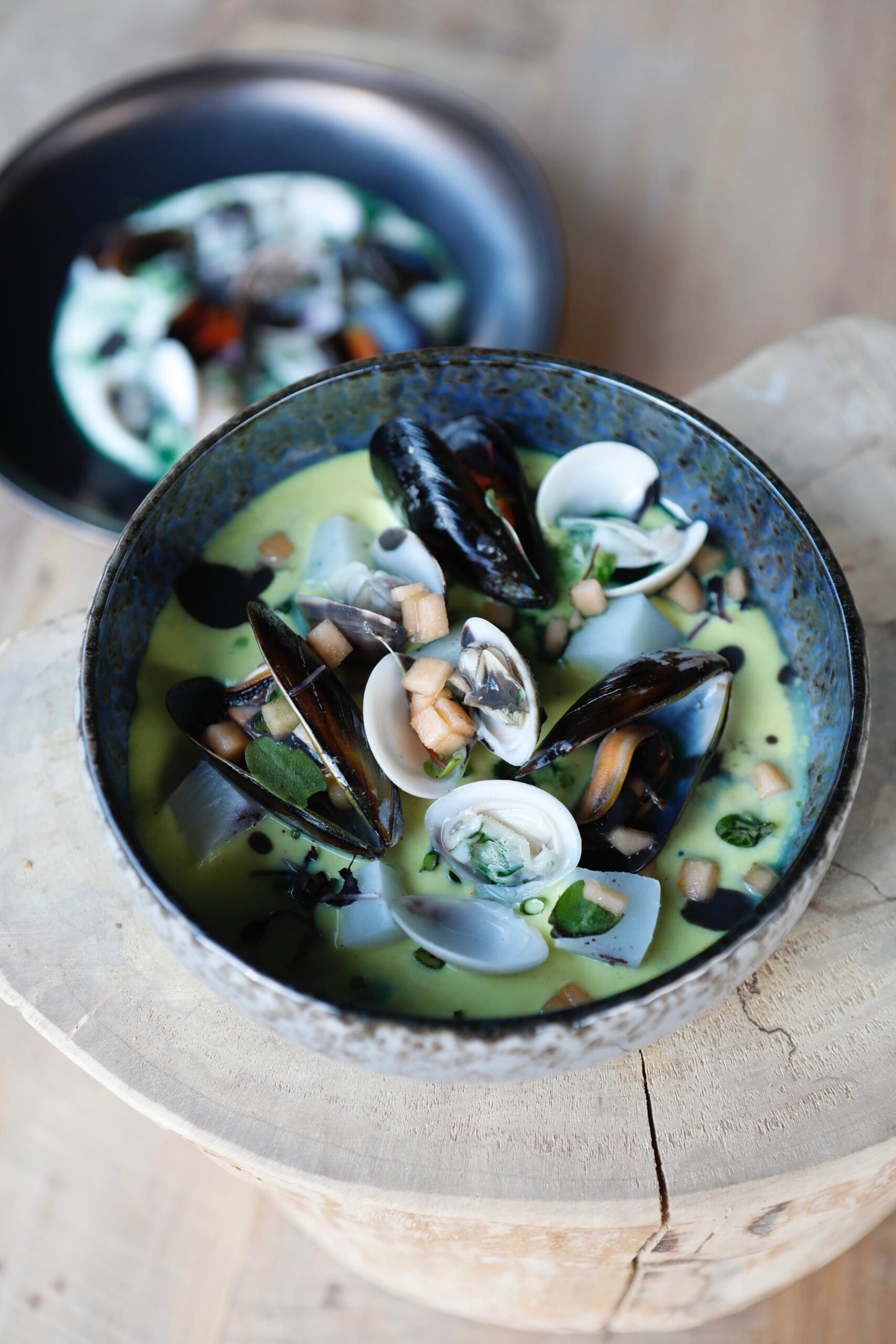 Venetian plated cappuccino, potatoes cream, mussels and cuttlefish