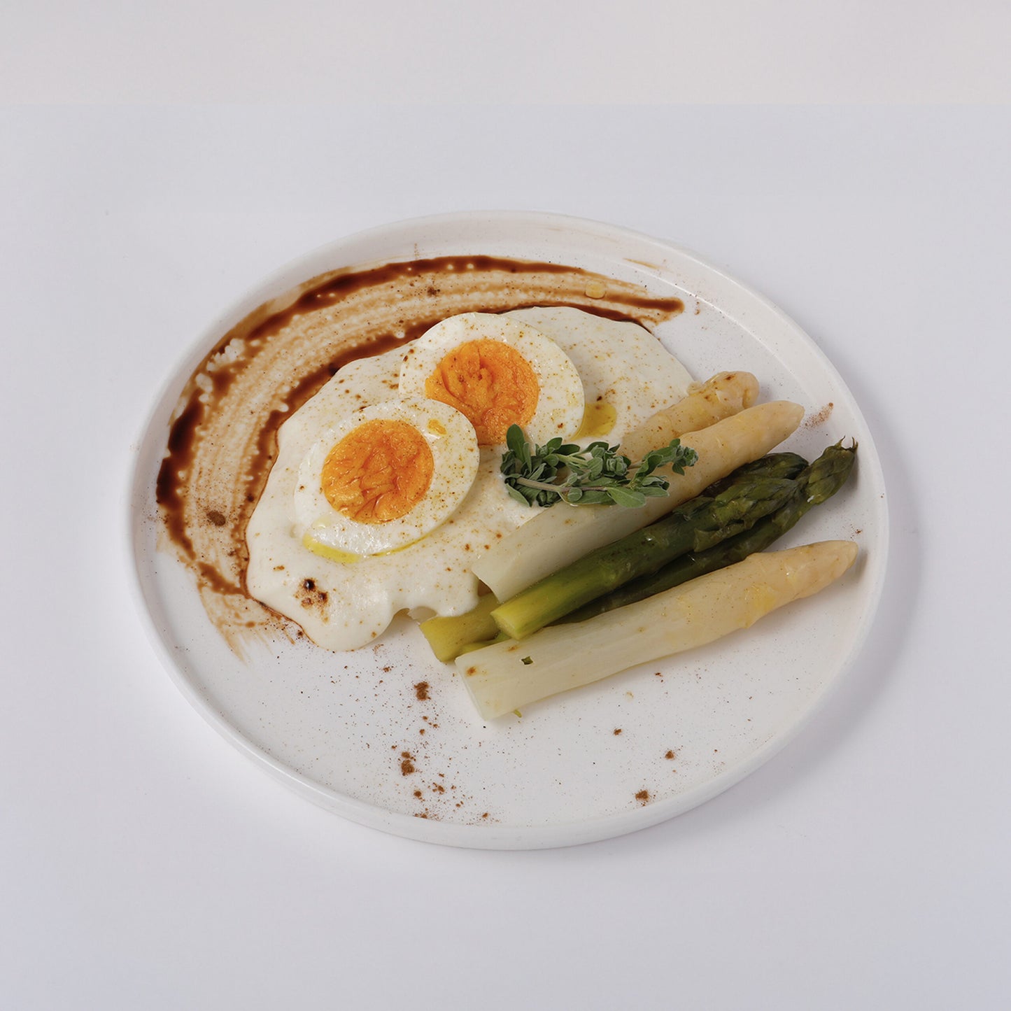 Eggs, white and green asparagus, potato cream and liquorice