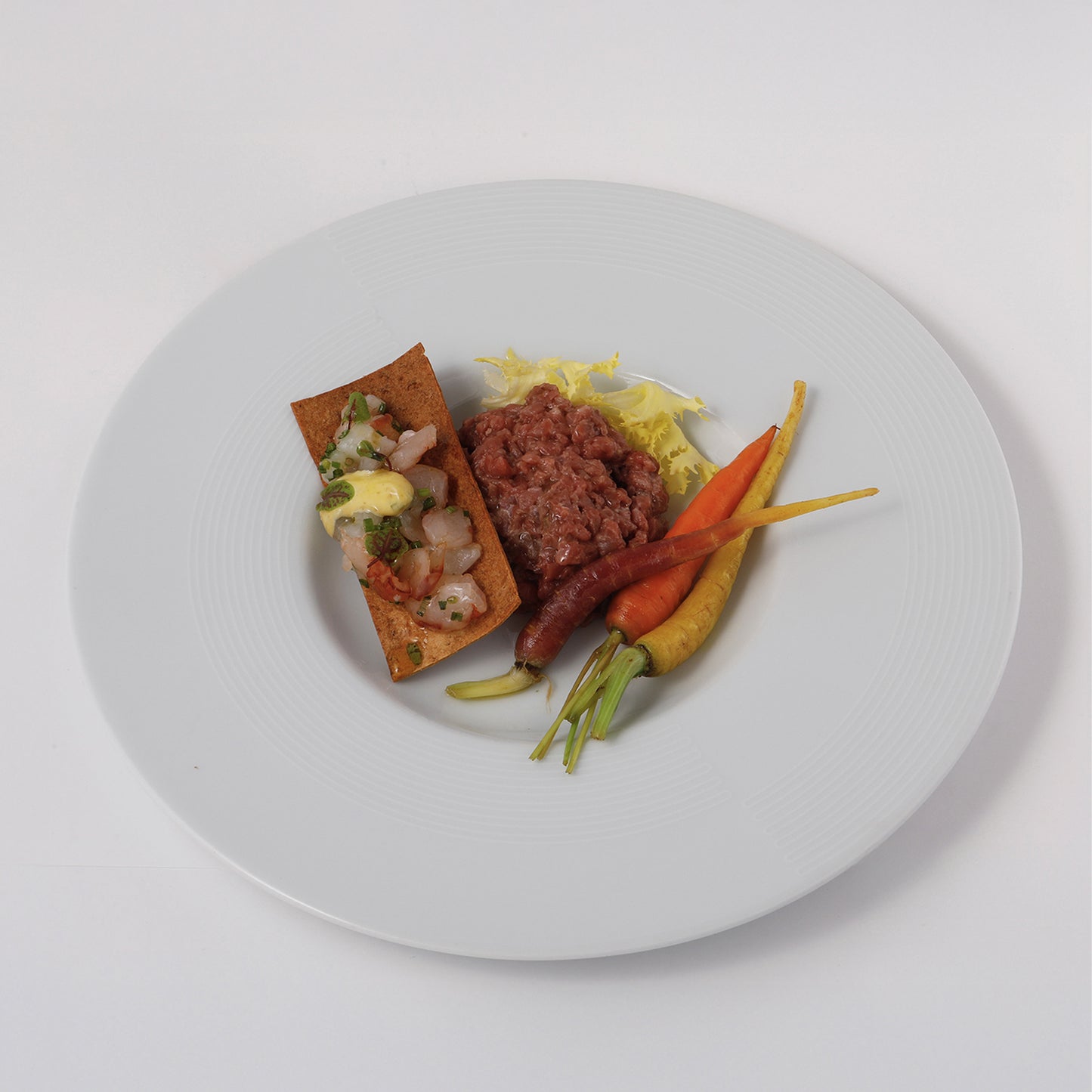 Mixed raw fish cracker, beef tartare, tarragon and old mustard mayo, baby carrots