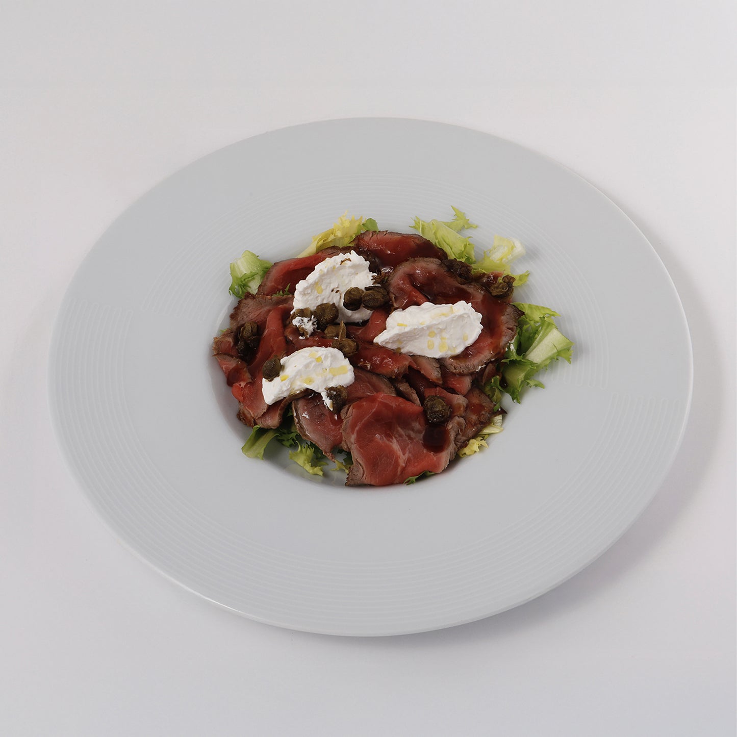 Roast beef, thyme ricotta, charcoal smoked oil, capers pop corns, curd salad, beef juice